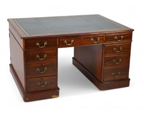 A Victorian mahogany partner's desk with green leather skiver, fitted nine drawers opposing three drawers and a pair of cupbo