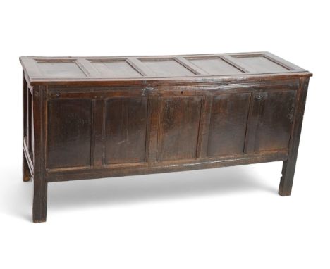 A 17th century oak coffer with five panel top, on squared stile feet, 172cm wide, 57cm deep, 85cm high Overall of a rich dark