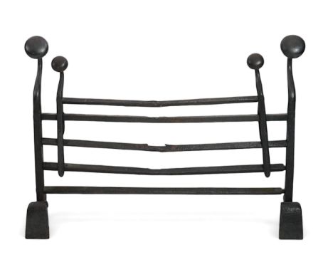 A 17th century French iron adjustable grate with roundel finials and stylised scroll feet, 89cm wide, 19cm deep, 63cm high So