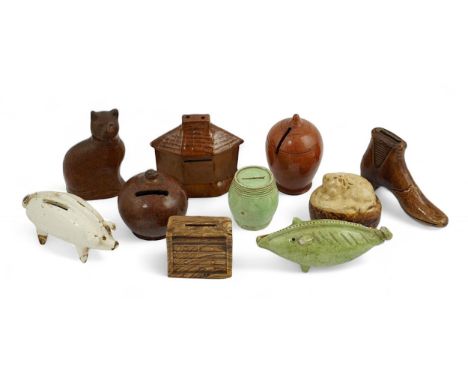 A collection of ten 19th century Dutch and British pottery money boxes comprising a pale green glazed pig and barrel, a brown