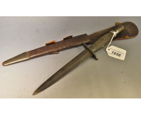 A Fairbairn Sykes commando knife in scabbard