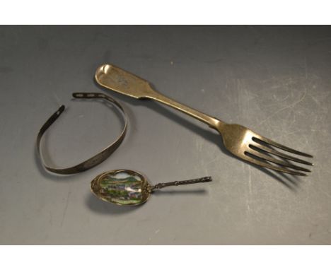 An early Twentieth century silver and enamel tea caddy spoon, the enamel decorated with a scene of Holyrood palace; a silver 