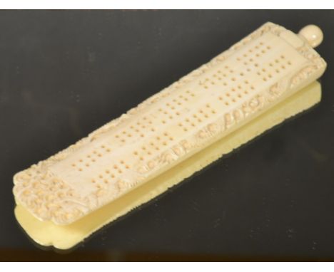 A Chinese carved ivory cribbage board, with counters