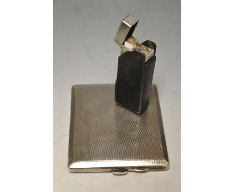 A Dunhill pocket leather, engine turned scaled decoration, cased; a silver rectangular cigarette case, Birmingham 1926 (2) 