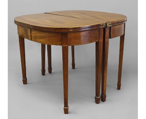 A PAIR OF GEORGE III MAHOGANY CARD TABLES, each with 'D' shaped tops with satinwood stringing enclosing baize lined playing s