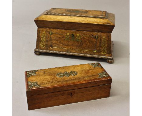 A REGENCY ROSEWOOD BRASS INLAID TEA CADDY, a sarcophagus shaped rosewood tea caddy with brass inlay and stringing, the interi