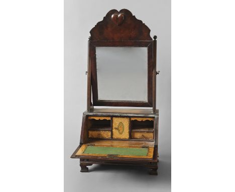 A QUEEN ANNE STYLE BUREAU FRONTED DRESSING TABLE MIRROR, the rectangular mirror beneath a wavy-edged frieze with central hear