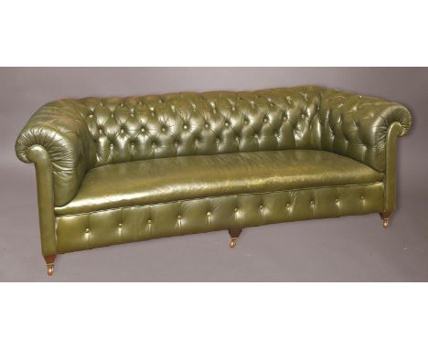 A LARGE GREEN LEATHER UPHOLSTERED CHESTERFIELD, with a broad button upholstered back, on short legs and castors, 73cm high, 2