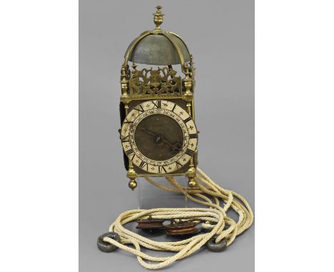 A BRASS LANTERN CLOCK SIGNED 'STAFFORD FREEMAN' LONDON, the silvered chapter ring with Roman numerals enclosing an engraved c