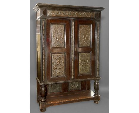 A LATE 19TH CENTURY COPPER MOUNTED CABINET, with a dark stained finish with broad moulded cornice above a frieze mounted with
