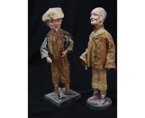 AN UNUSUAL PAIR OF JAPANESE FIGURES, male and female, realistically modelled with composition heads and silk and straw costum