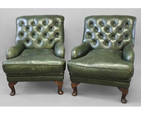 A PAIR OF GREEN LEATHER CLUB TYPE ARMCHAIRS, each with broad button upholstered backs and deep seats with low arms, on short 