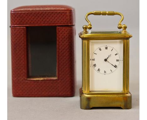 A MINIATURE CARRIAGE CLOCK, with white enamel dial with roman numerals, the single train movement stamped 'J D', in fitted re