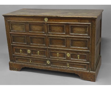 AN EARLY 18TH CENTURY MULE CHEST, with a broad rectangular top above a front with eight recessed rectangular panels and a pai
