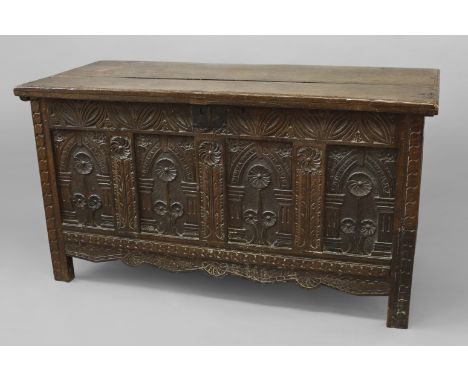AN OAK COFFER WITH CARVED FOUR PANEL FRONT, late 17th/early 18th century with a two plank top enclosing an interior with lidd