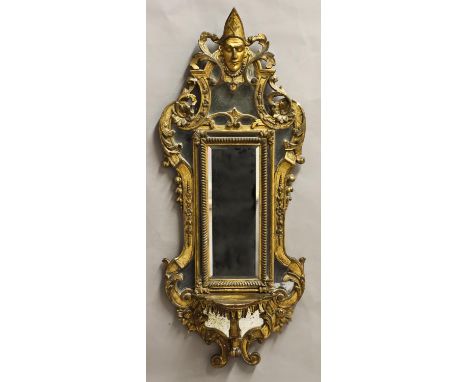 AN UNUSUAL GILTWOOD WALL MIRROR, with a central rectangular bevel edged plate with a lobed border flanked by smaller mirror p