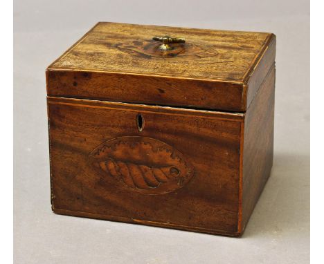 A GEORGE III MAHOGANY TEA CADDY, of rectangular form, the lid and front with oval panels of shell inlay and stringing to the 