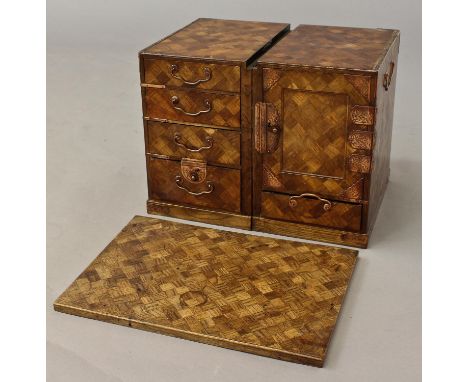 A JAPANESE PARQUETRY TABLE TOP CABINET, the removable top on two pedestals containing a cupboard and a selection of five smal