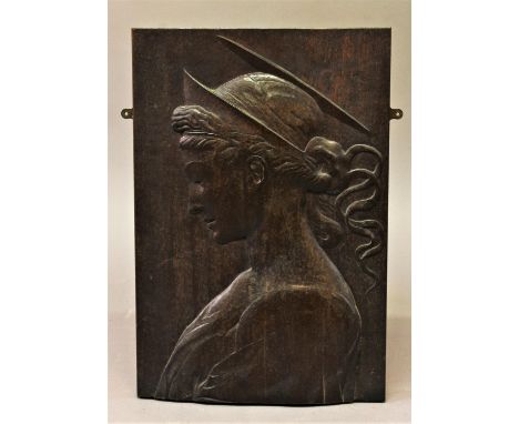 A LOW RELIEF CARVED PANEL, a rectangular mahogany panel carved in low relief with a female saint or similar figure with a hal