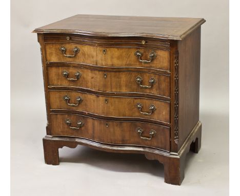 A GEORGE III STYLE MAHOGANY SERPENTINE FRONTED CHEST,&nbsp;the shaped top with a moulded border above a brushing slide and fo