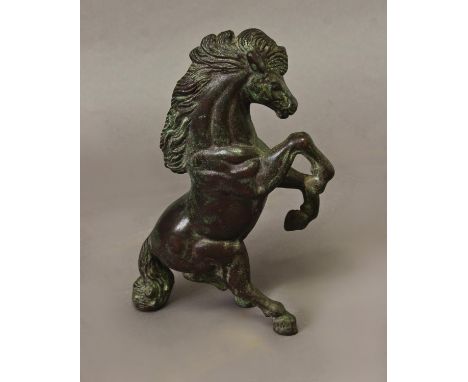 A CAST AND PATINATED BRONZE STUDY OF A REARING HORSE, the horse with flowing mane and tail rearing on its hind legs, possibly