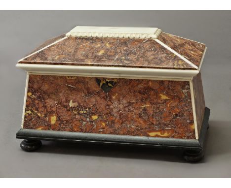 A MONUMENTAL REGENCY STYLE MARBLE TEA CADDY, of sarcophagus shape with rouge marble panels and slate base and feet, fitted wi