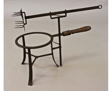 AN UNUSUAL 18TH CENTURY TRIVET TOASTER, with an eight pronged toasting fork on an adjustable bracket and rising mechanism, wi