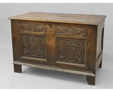A 17TH CENTURY OAK COFFER WITH TWO PANEL FRONT, with a three plank top with moulded border on original pin hinges, the front 