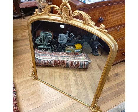 An early 20th century gilt gesso overmantel mirror, with a pierced finial, 120 x 100 cm 