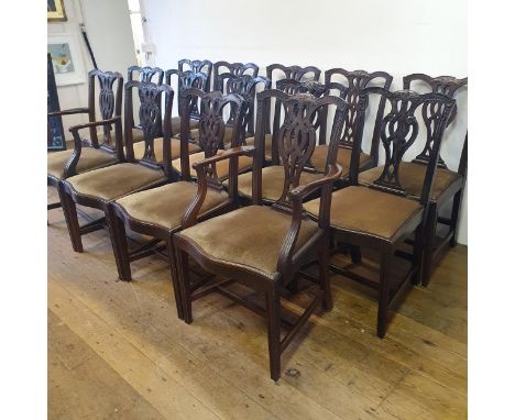 A matched set of fourteen Chippendale style mahogany dining chairs, with carved top rails, pierced splat backs and drop in se
