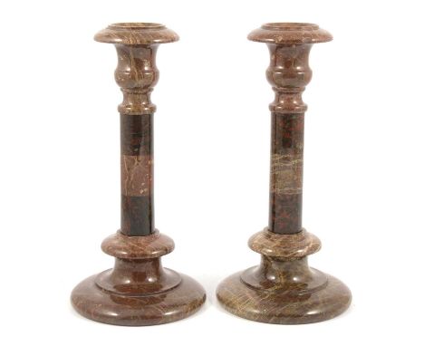 Pair of red serpentine marble candlesticks, urn-shape sconces, turned columns, circular bases, 27cm.Condition report:One stic