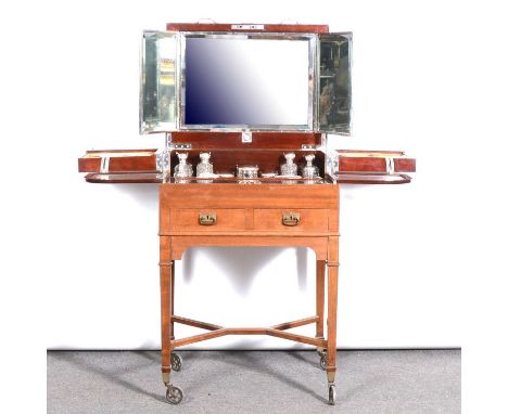 A German fitted mahogany dressing table, early 20th century, metamorphic design, with a comprehensive suite German silver-mou