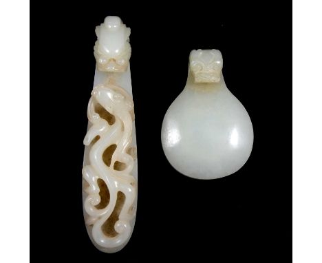 A Chinese pale jade belt buckle, 19th or 20th century, with a dragon’s head and lizard, length 12cm; and a pale jade buckle c