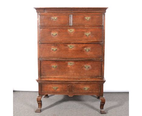 An oak chest on stand, basically late 17th century, cavetto moulded cornice section, fitted with two short and three long dra