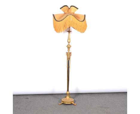 Italian gilt metal standard lamp, decorated with acanthus and rams masks, circular base on three paw feet, with shade, height
