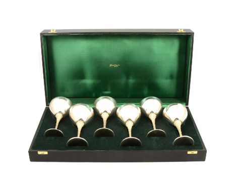 Set of six parcel gilt silver goblets, Stuart Devlin, London 1978, planished bowls with gilt interior, raised on a leaf textu