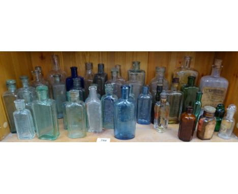 A shelf of aqua and other Vintage bottles 