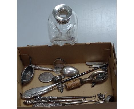 A glass decanter with silver collar, silver handled button hooks etc. 