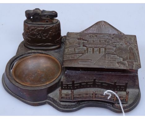 A Japanese antimony desk stand with relief cast lid, and matching lighter, width 6" 