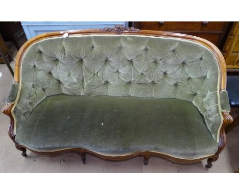 A Victorian mahogany-framed parlour sofa, with floral carved show wood surround, shaped front and cabriole legs 