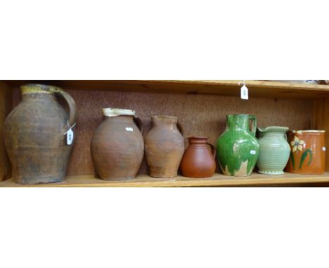 A shelf of earthenware jugs, tallest 11.5" 