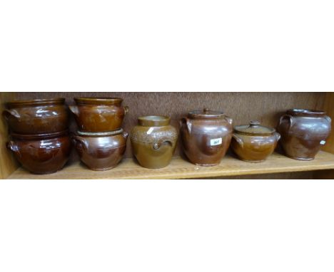 A shelf of 2-handled pots 