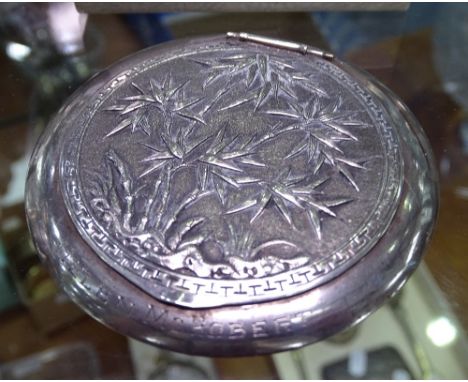 An engraved and embossed Chinese silver compact 