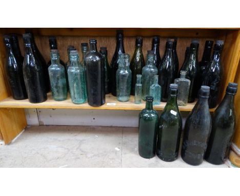 A shelf of aqua, beer and brewery bottles 