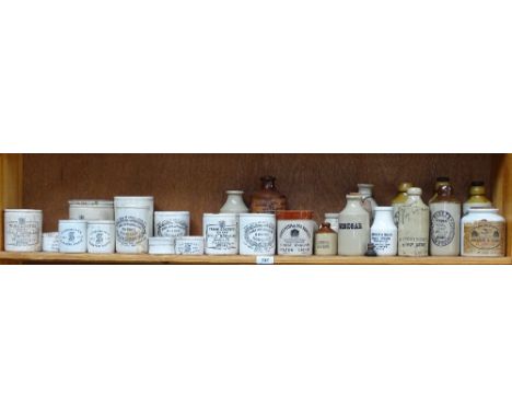 A shelf of printed stoneware jars etc 