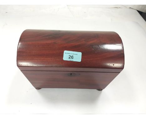 A Georgian mahogany dome top tea caddy on bun feet with two interior compartments.