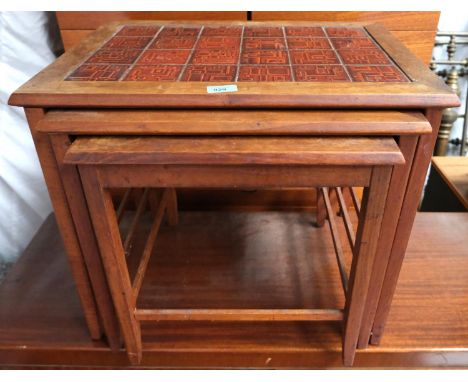 A mid 20th Century Danish teak tile top nest of three tables with geometric patterns.