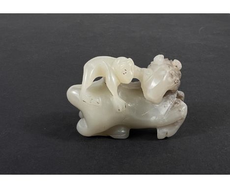 A carved Chinese jade coloured hard stone horse with monkey on its back, length 5cm