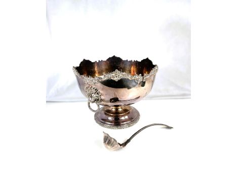 A large silver plate punch bowl and ladle.