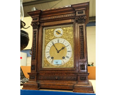 A Victorian carved oak bracket clock with brass dial and ting tang movement. Fretting damaged with loss on RHS sound panel. O